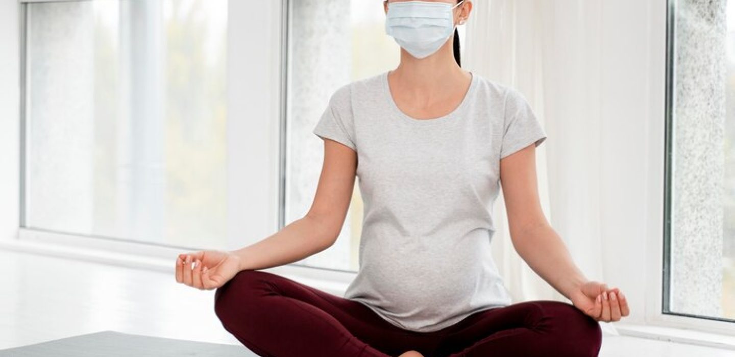 pregnant-woman-with-medical-mask-meditating_23-2148752204